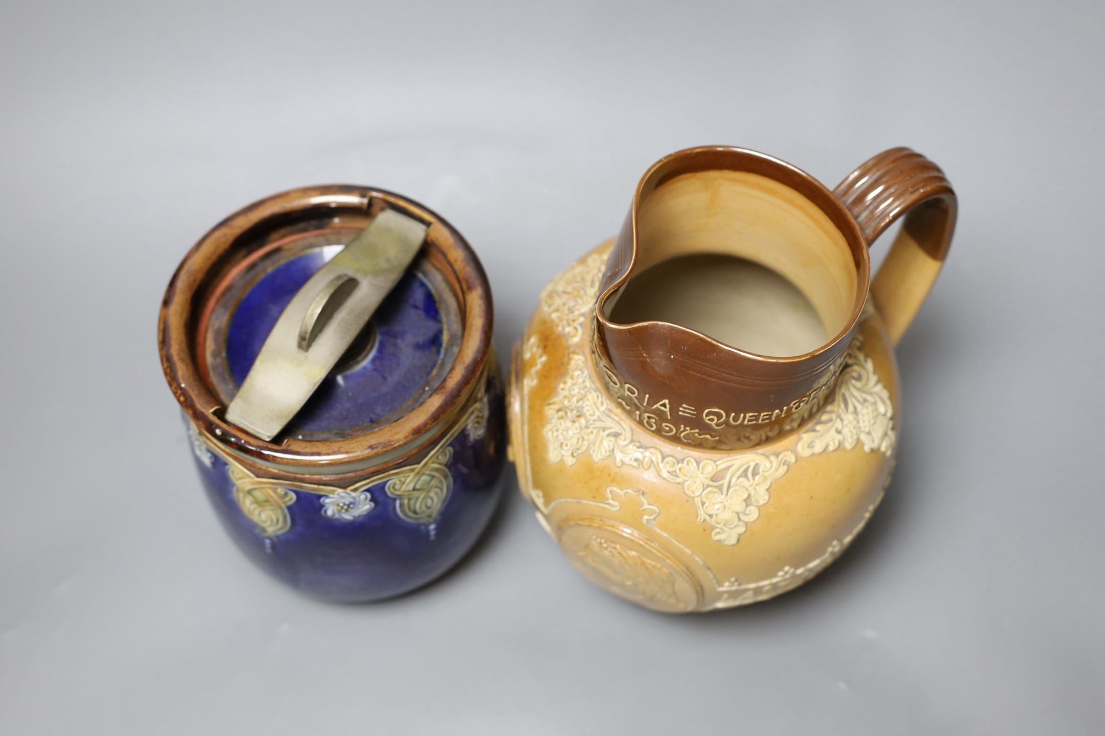 A Doulton Lambeth stoneware tobacco jar and a Queen Victoria Diamond Jubilee commemorative jug, jug 19cms high